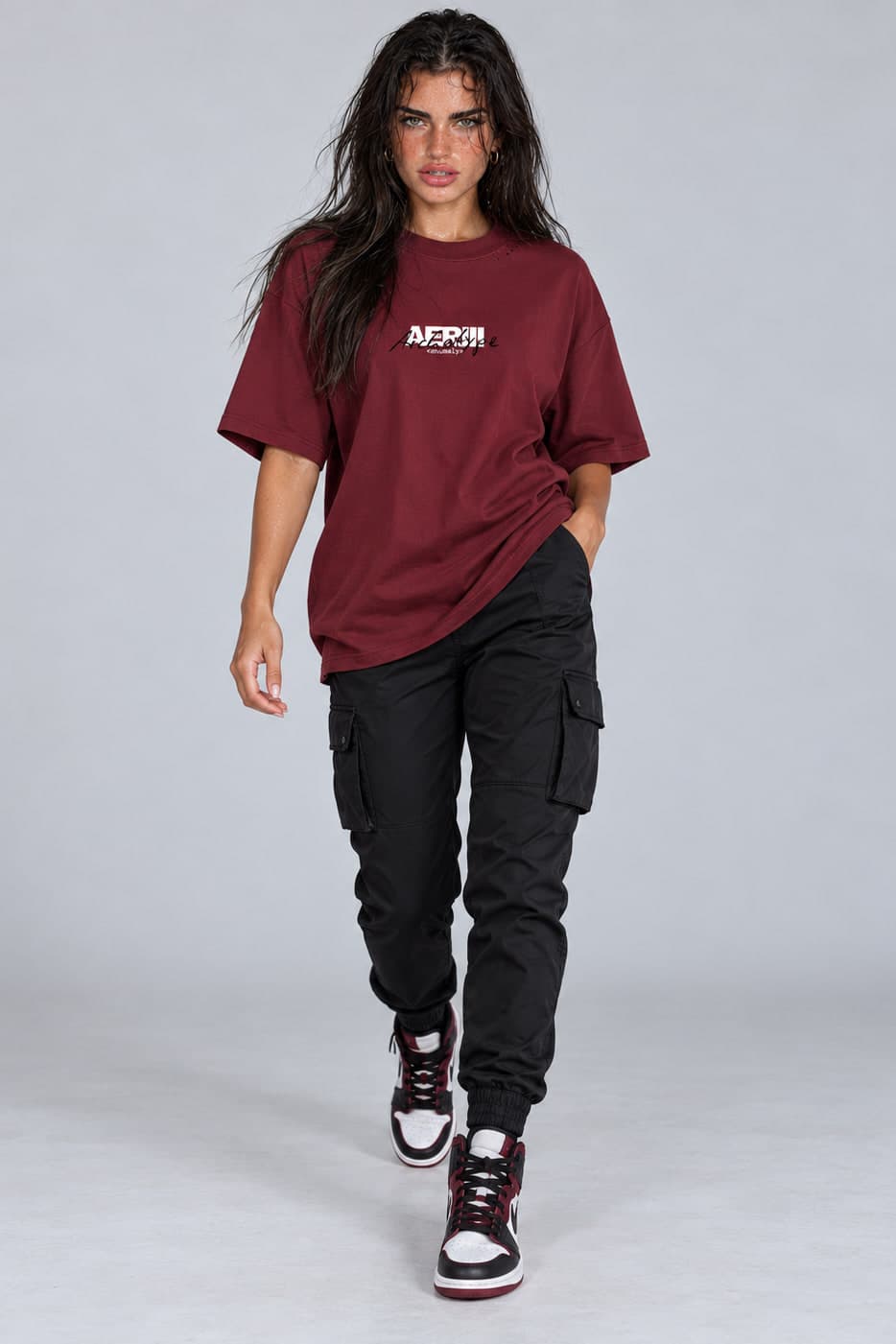ARCHETYPE tee in burgundy, walking, on a female model