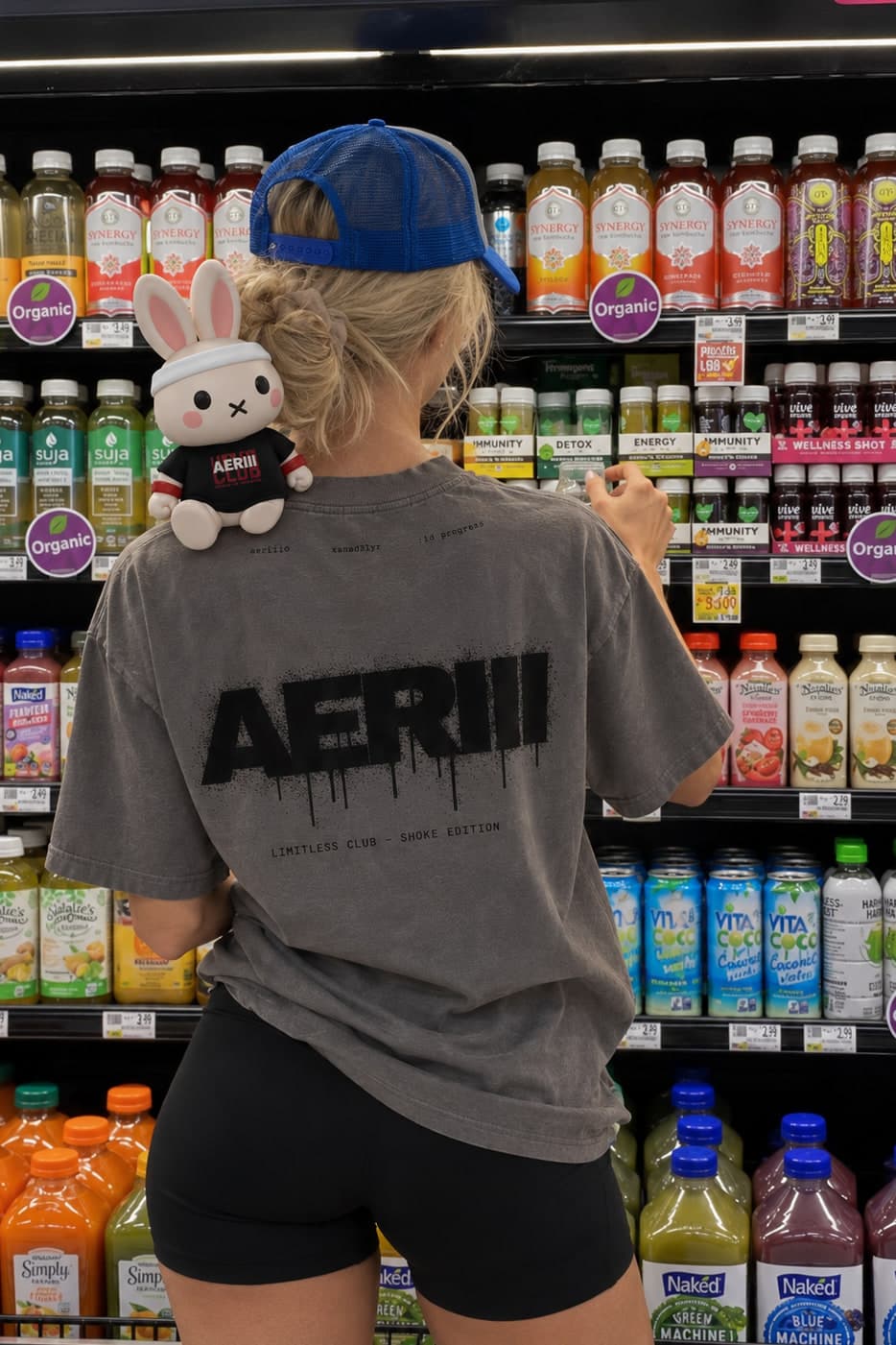 SMOKE EDITION tee in smoke, the sprayed back print, in a supermarket aisle with the bunny on her shoulder